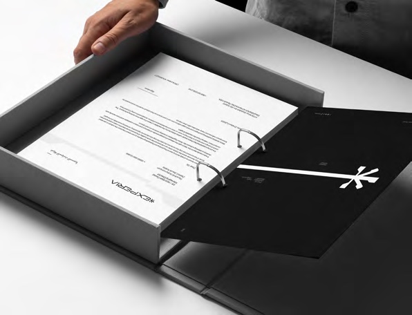 Hand lifting an Experia card from a black presentation box