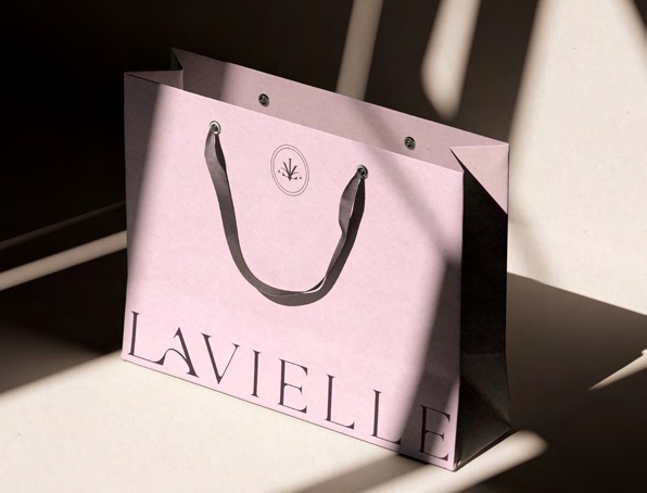 Pale pink Lavielle shopping bag held in daylight